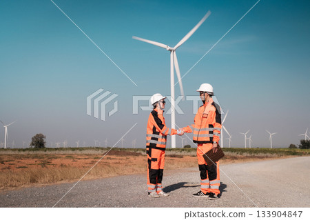 Engineers are inspecting wind turbines to generate electricity. 133904847