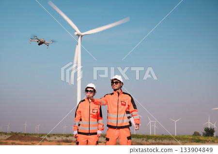 Engineers are inspecting wind turbines to generate electricity. 133904849