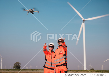 Engineers are inspecting wind turbines to generate electricity. 133904852
