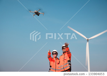 Engineers are inspecting wind turbines to generate electricity. 133904853