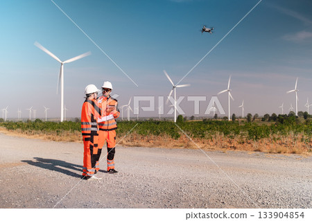 Engineers are inspecting wind turbines to generate electricity. Engineers are inspecting wind turbines to generate electricity. 133904854