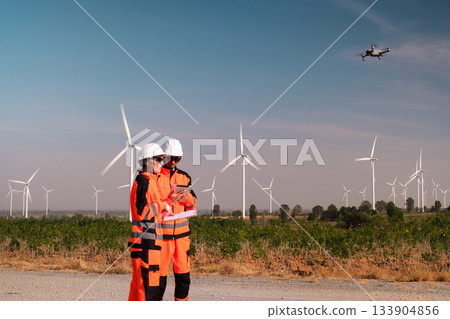 Engineers are inspecting wind turbines to generate electricity. Engineers are inspecting wind turbines to generate electricity. 133904856