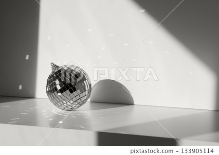 Disco ball in sunlight with reflections on minimal background. Geometric shadows color of 2026 year cloud white 133905114