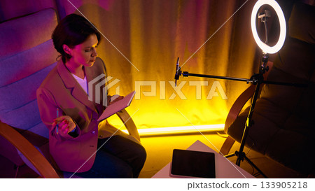 Woman coaching online with phone and ring light Woman coaching online with phone and ring light 133905218