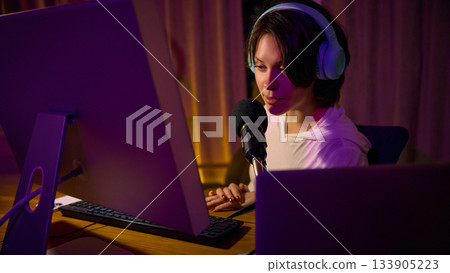 Woman recording podcast with headphones and microphone at home setting Woman recording podcast with headphones and microphone at home setting 133905223
