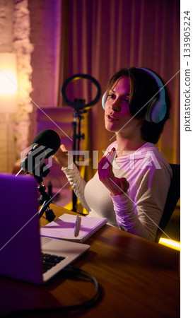 Woman speaking confidently into microphone during webinar Woman speaking confidently into microphone during webinar 133905224