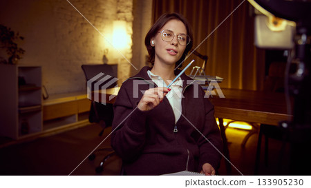 Woman explaining idea with pencil during online session 133905230