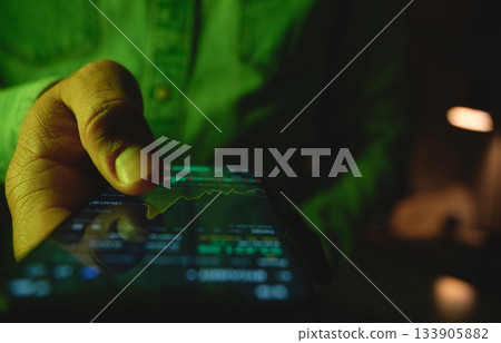 Hand using smartphone for online stock market investment Hand using smartphone for online stock market investment 133905882