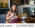 Woman Enjoying Dessert at Cafe 133905960