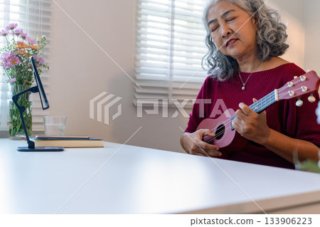 Senior Woman Using Tablet For learning Instrument Senior Woman Using Tablet For learning Instrument 133906223