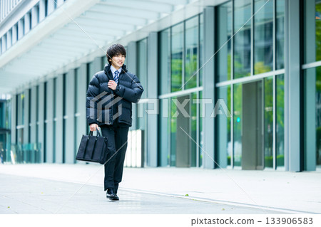 Smiling businessman wearing a down jacket 133906583