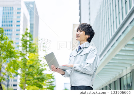 A young man wearing work clothes 133906605