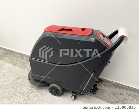 Industrial vacuum cleaner with floor dust suction. Professional cleaning equipment. Heavy duty cleaner in public area using push type vacuum cleaner. Concept of cleanliness and dirt removal Industrial vacuum cleaner with floor dust suction. Professional cleaning equipment. Heavy duty cleaner in public area using push type vacuum cleaner. Concept of cleanliness and dirt removal 133906836