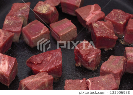 Meat cooked on a frying pan, diced steak Meat cooked on a frying pan, diced steak 133906988