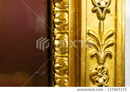 Exquisitely detailed gilded frame featuring raised floral motifs 133907255