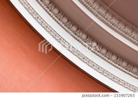 Intricate close-up of a beaded plaster ceiling molding 133907263