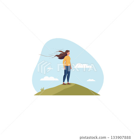 Woman standing atop a grassy hill gazing out at the sky a sense of aspiration and contemplation 133907888