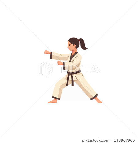 Focused female martial artist practices self-defense techniques and discipline while wearing her Focused female martial artist practices self-defense techniques and discipline while wearing her 133907909