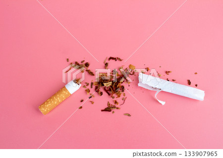 cigarette butts torn on pink background cigarette butts torn on pink background 133907965