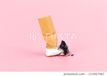 cigarette butts on pink background cigarette butts on pink background 133907967