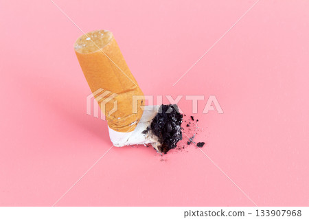 cigarette butts on pink background cigarette butts on pink background 133907968