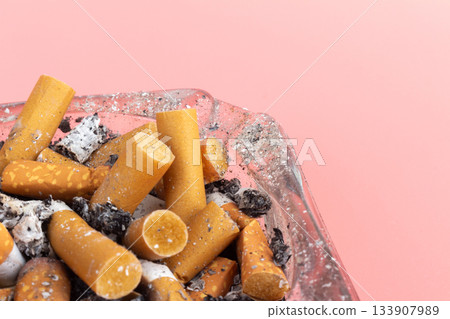 cigarette butts torn on pink background ashtray 133907989