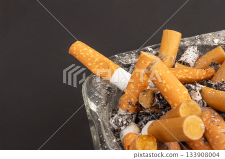 cigarette butts torn on black background ashtray 133908004