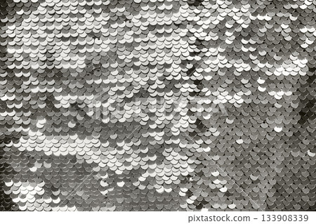 Close up of shiny silver sequins creating an abstract pattern. Color of the year concept Close up of shiny silver sequins creating an abstract pattern. Color of the year concept 133908339