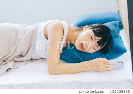 A woman who fell asleep with a smartphone A woman who fell asleep with a smartphone 133908588