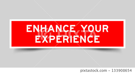 Red color square shape sticker label with word enhance your experience on gray background Red color square shape sticker label with word enhance your experience on gray background 133908654