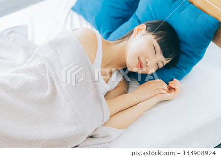 A woman sleeping in bed A woman sleeping in bed 133908924