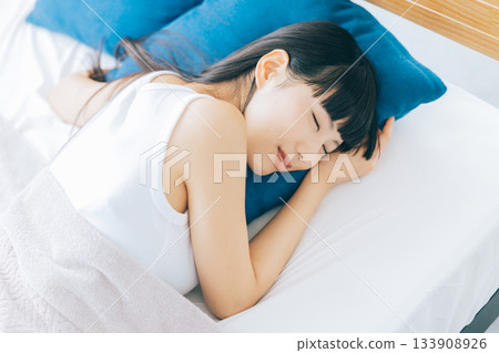 A woman sleeping in bed A woman sleeping in bed 133908926