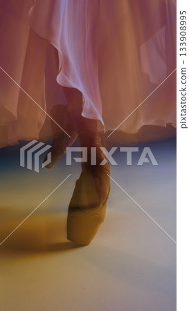 Ballet pointe shoes close-up under pastel fabric with soft emotional motion Ballet pointe shoes close-up under pastel fabric with soft emotional motion 133908995