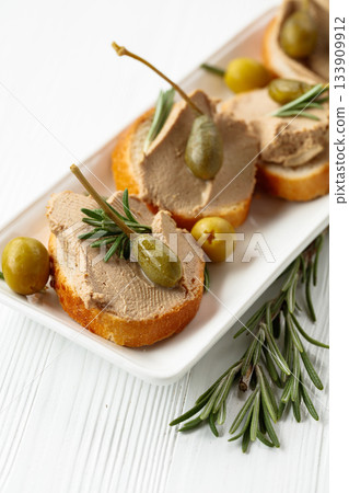 Sandwiches with pate on a white wooden table. 133909912