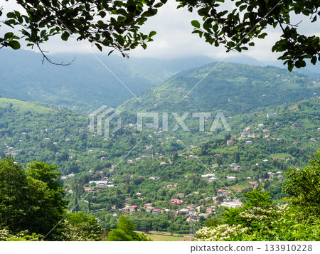 view of settlements on green slope from Erge mount 133910228