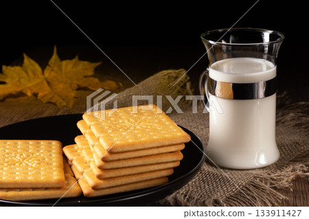 A cozy kitchen scene featuring milk and crackers for a comforting snack time 133911427