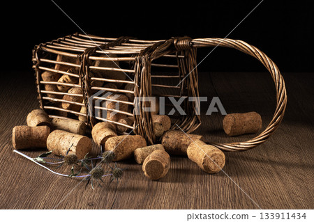 Stylish retro basket filled with wine corks resting on an elegant table Stylish retro basket filled with wine corks resting on an elegant table 133911434