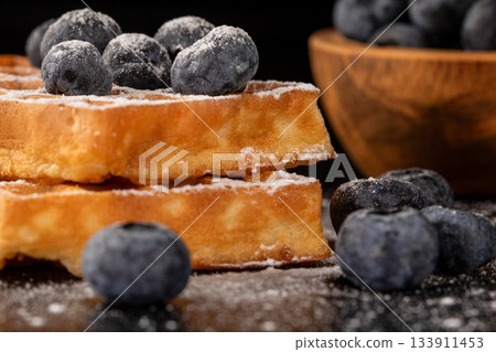 Mouthwatering belgian waffles with blueberries and powdered sugar Mouthwatering belgian waffles with blueberries and powdered sugar 133911453