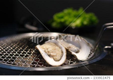 close up of yummy oysters are on the grill with fire close up of yummy oysters are on the grill with fire 133911475
