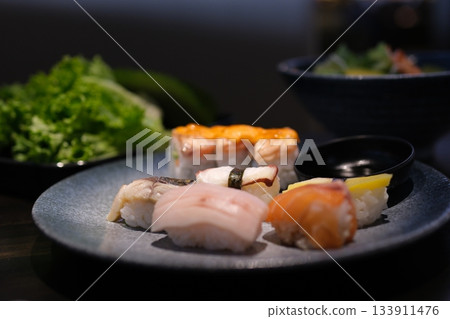 Flying sushi pieces are placed between chopsticks. Sushi and roll levitation with soy sause. Flying sushi pieces are placed between chopsticks. Sushi and roll levitation with soy sause. 133911476