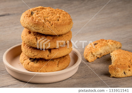 Cookie lovers delight: raisin dessert cookies on a rustic table setting 133911541