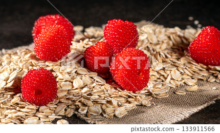 A colorful display of tibetan raspberries with oatmeal flakes for healthy meals 133911566