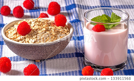 Healthy breakfast concept featuring yogurt, oatmeal flakes, and tibetan raspberry berries Healthy breakfast concept featuring yogurt, oatmeal flakes, and tibetan raspberry berries 133911568