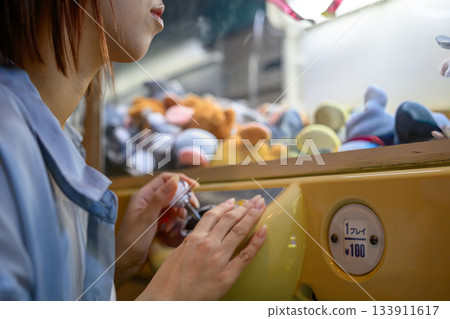 Close-up of a young woman playing at an arcade on a ferry 133911617