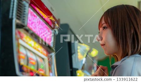 A woman playing slots on a ferry to Okinoshima Island 133911622