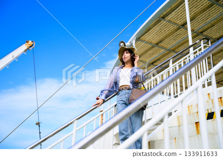 Female traveller on the ferry deck heading to Oki Island 133911633