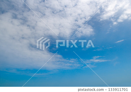 Bright Blue Sky Background with White Cirrocumulus and Stratus Clouds 133911701
