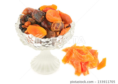 Dried Apricots, Dates, and Candied Fruit in a Glass Vase on White Dried Apricots, Dates, and Candied Fruit in a Glass Vase on White 133911705