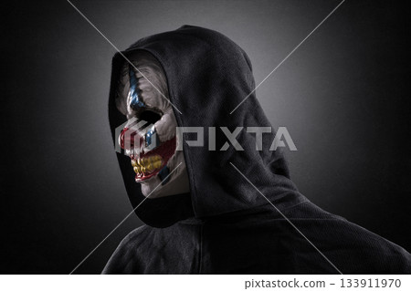 Portrait of a scary clown over dark misty background with clipping path 133911970