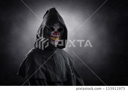 Portrait of a scary clown over dark misty background with clipping path 133911973